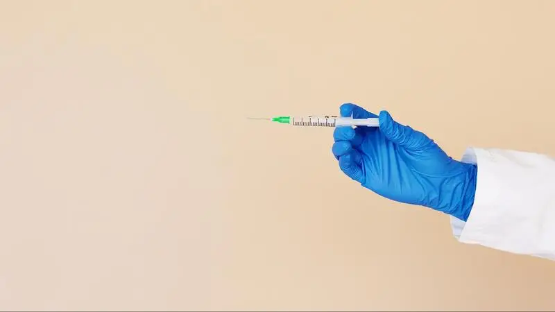 a man holding a syringe