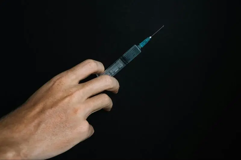 Man holding a syringe