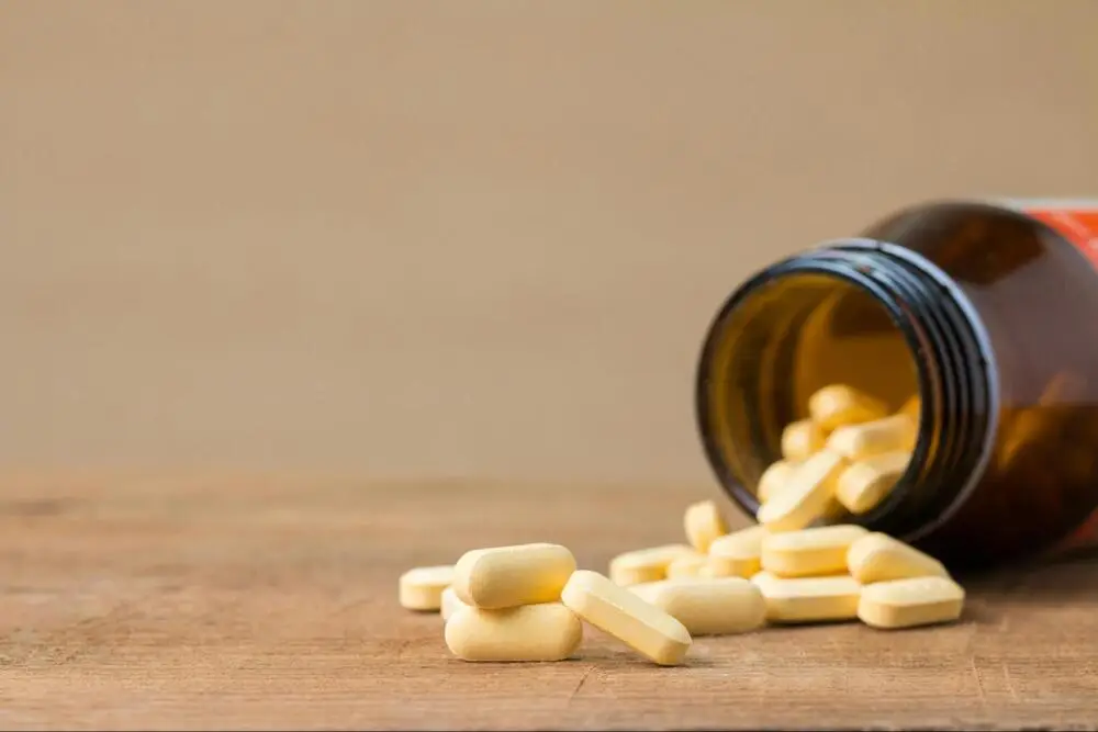 Bottle of medicine tipped over with pills spilling out