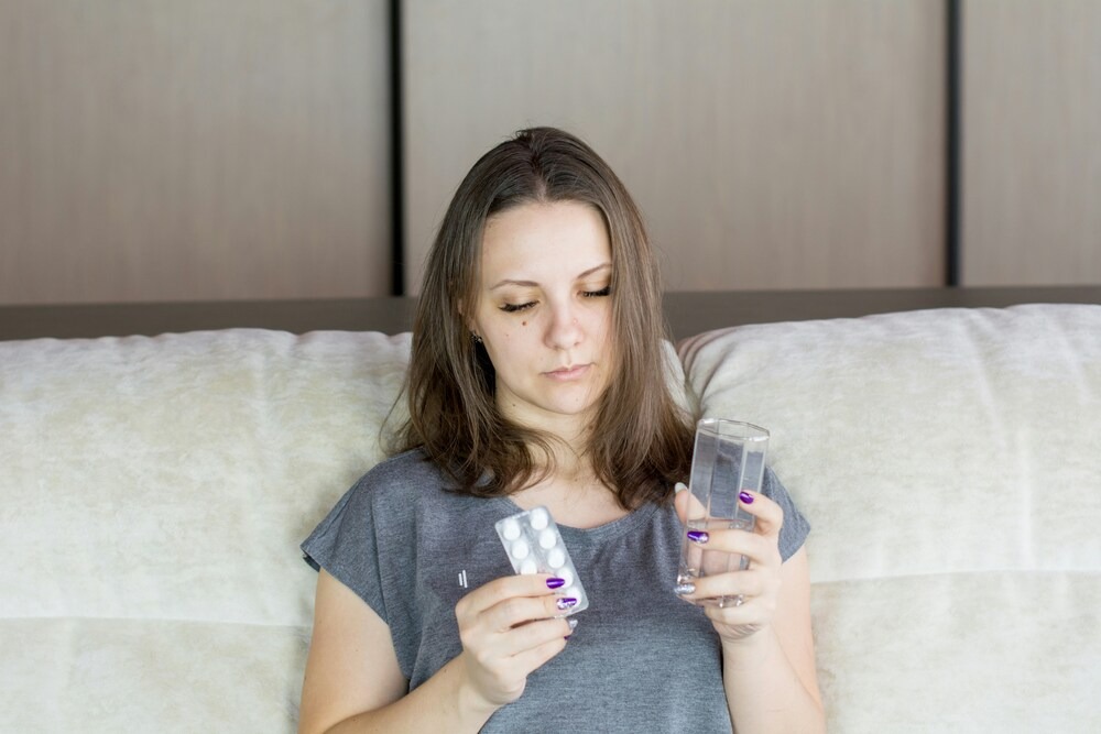 A woman with medications in her hand